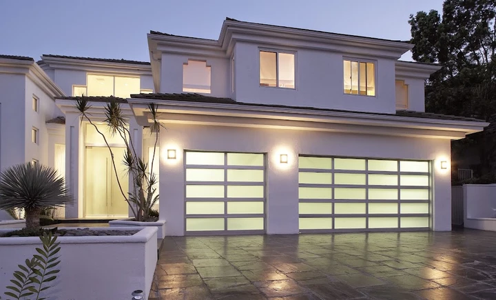 Modern home with glass panel garage doors.