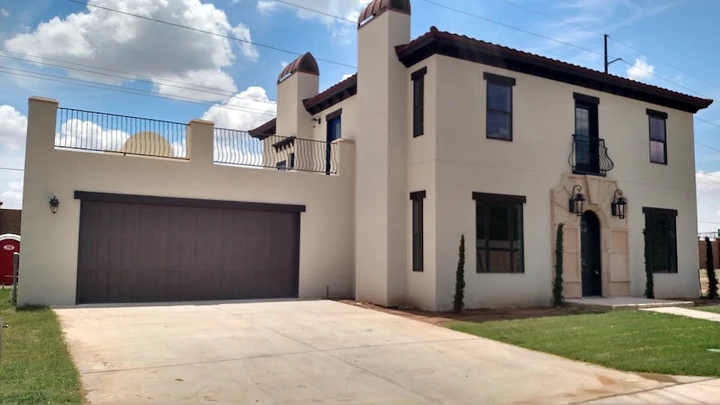 Modern two-story house with brown garage door.