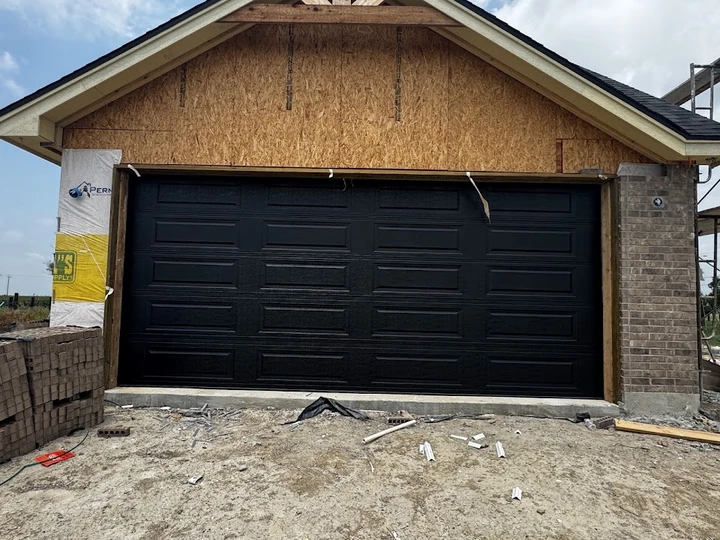 New black garage door installation by Affordable.