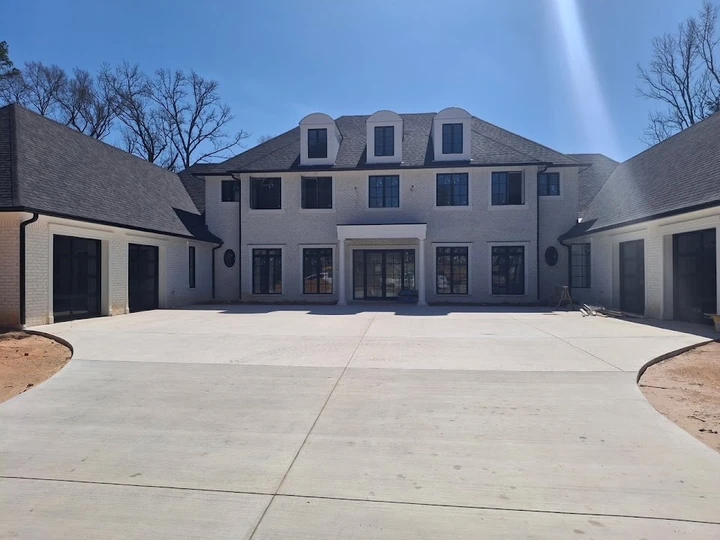 New home with modern black garage doors.