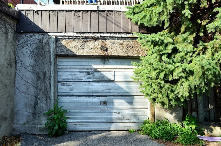 Old garage door in need of professional repair.