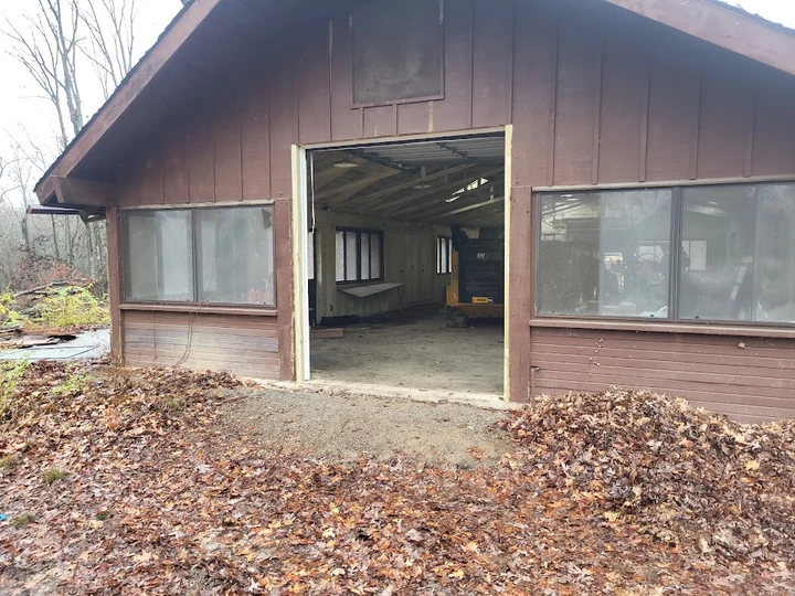 Open garage door of a wooden shop building.