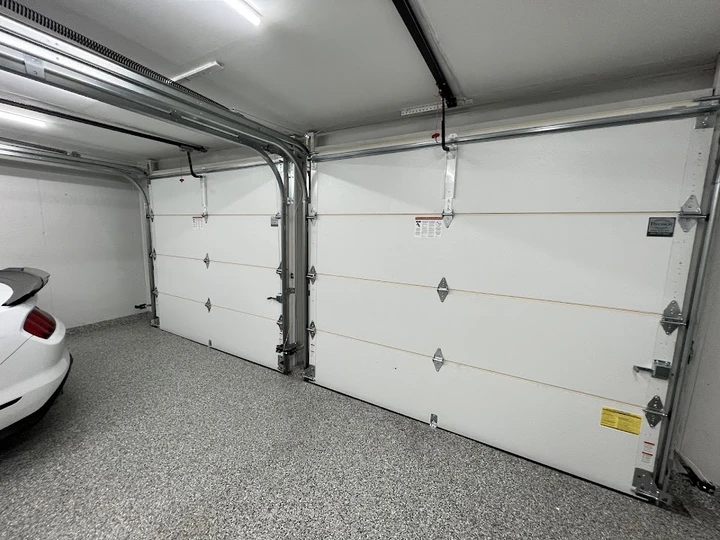 Precision Overhead garage doors in a home garage.