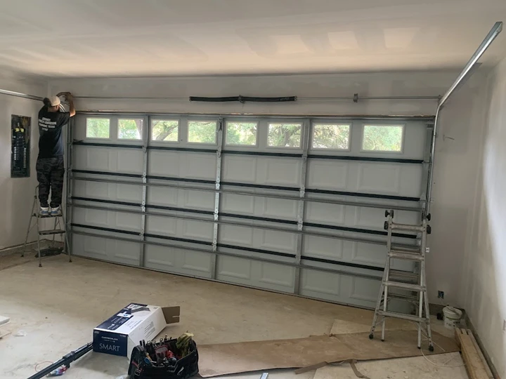 Technician installing a garage door.