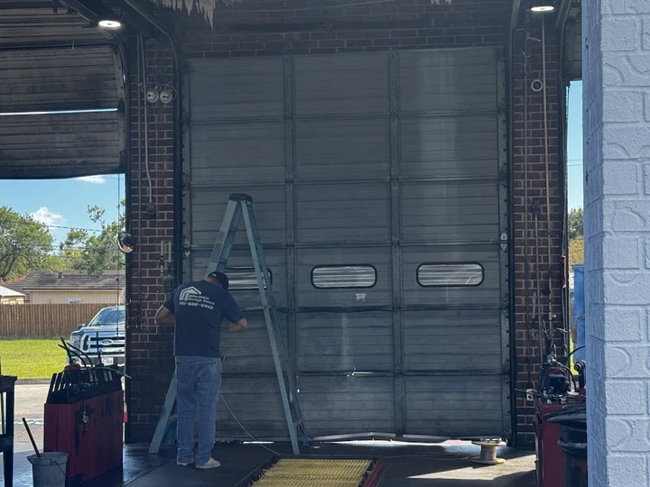 Technician servicing a garage door.