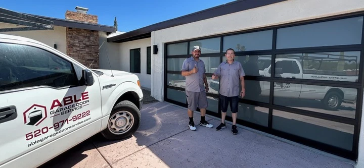 Technicians in front of a new garage door.