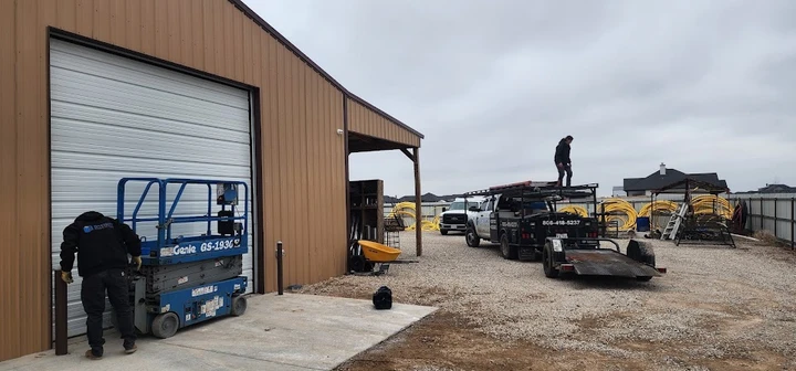 Technicians working at an Integrity Overhead Door site.