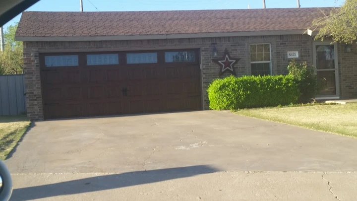 Traditional brown carriage-style garage door.