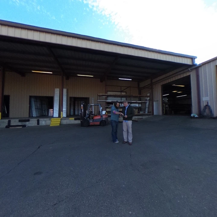 Two men discussing at an Overhead Door Tyler facility.