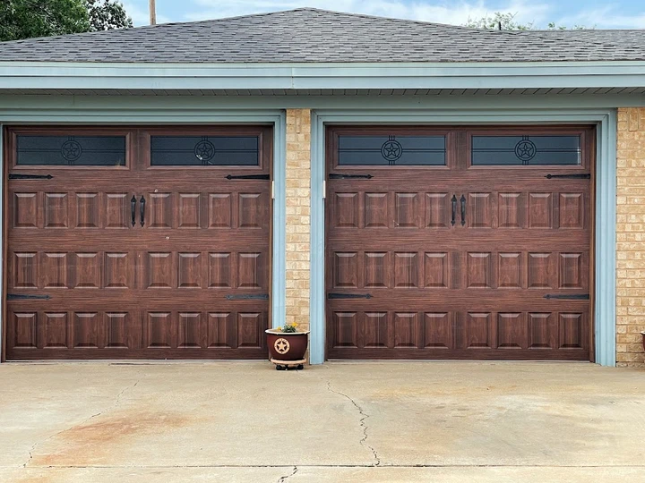 Two wooden garage doors with star accents.