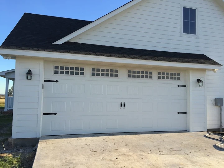 White garage door with windows by Aladdin Overhead.