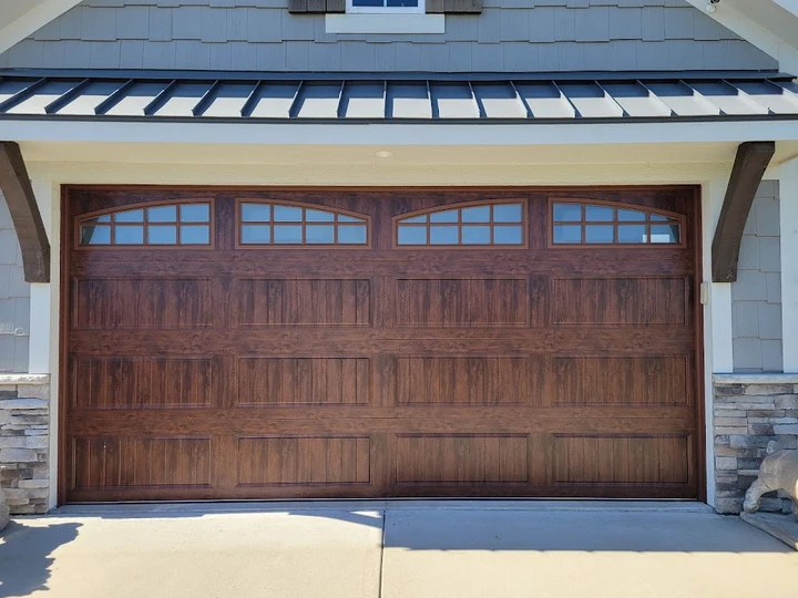 Wood-look residential garage door by JV Garage Door.