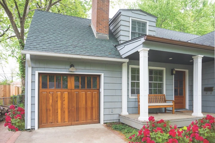 Wooden carriage house garage door with windows.