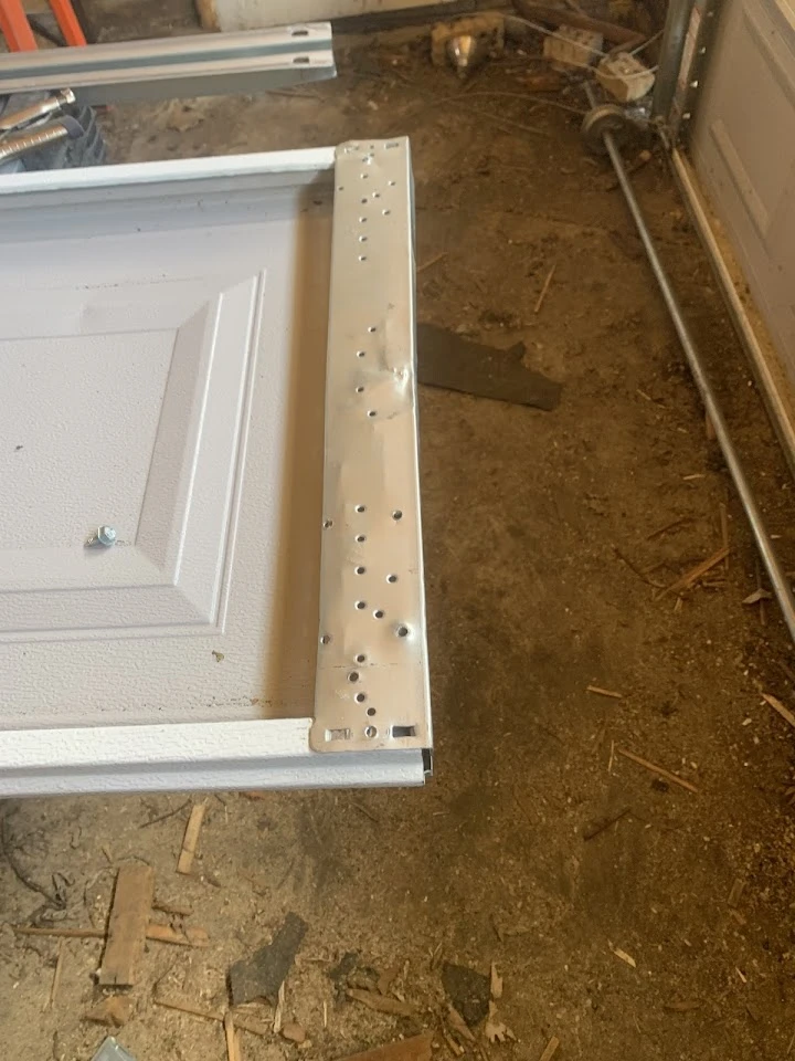 Damaged garage door hinge plate.