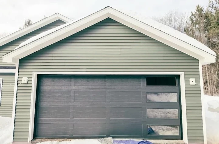 Dark garage door with right-side windows by American Door & Supply.