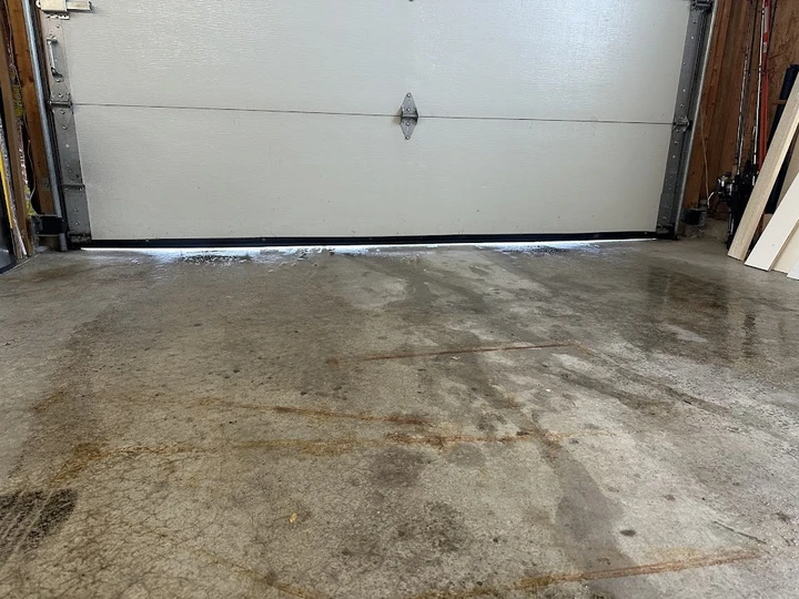Gap under garage door showing daylight.