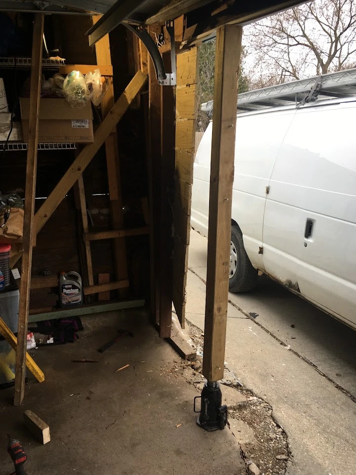 Garage door frame repair with a jack post.
