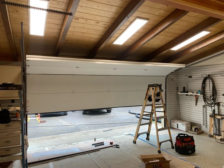 Garage door installation in progress by professionals.