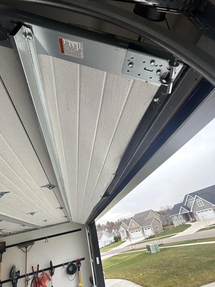 Garage door mechanism inside a residential garage.