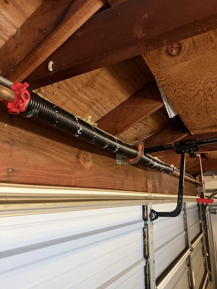 Garage door torsion spring and opener arm.