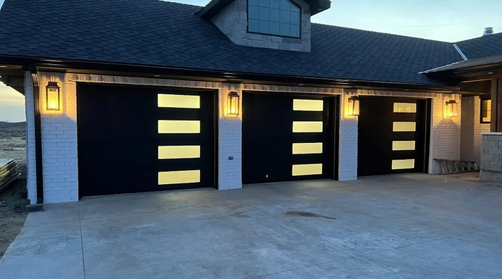 Modern black garage doors with frosted glass panels.