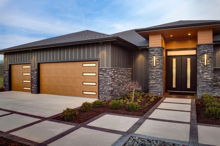 Modern home exterior with custom wood-look garage doors.