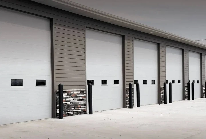 Row of white commercial overhead garage doors.