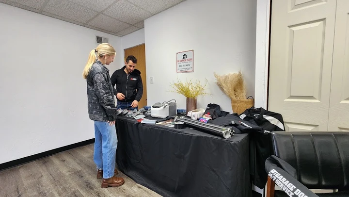 Staff showing garage door parts to a customer.