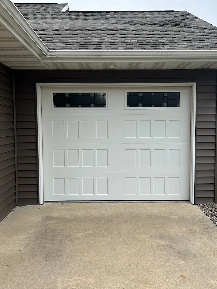 White garage door with rectangular windows.