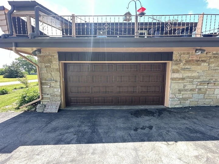 Wood-grain garage door by M & L Garage Door Service.